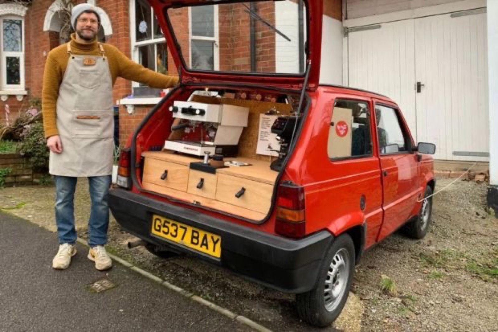 Red vintage hatchback with mobile espresso installation